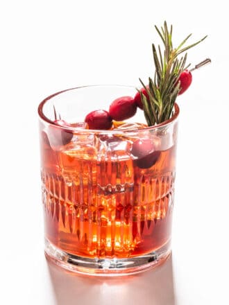 A Cranberry Bourbon Sour with a rosemary sprig
