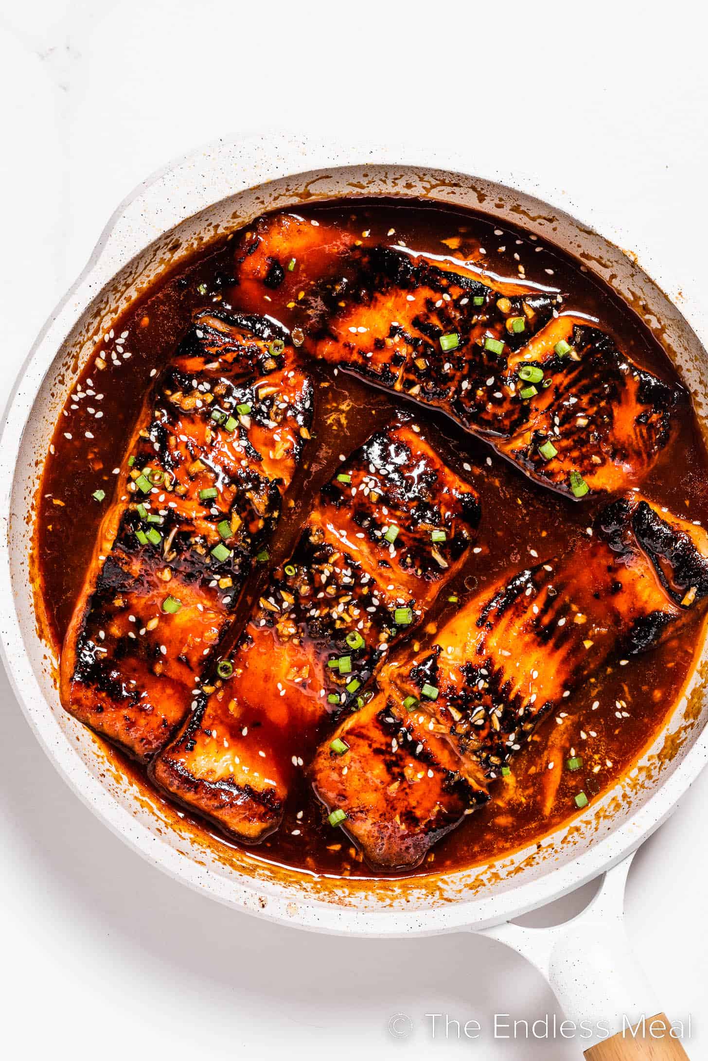 sweet and spicy firecracker salmon in a frying pan