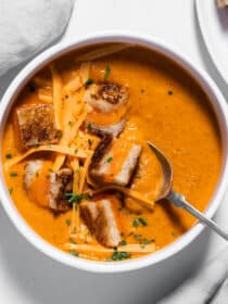 Tomato Cheddar Soup in a bowl with grilled cheese croutons