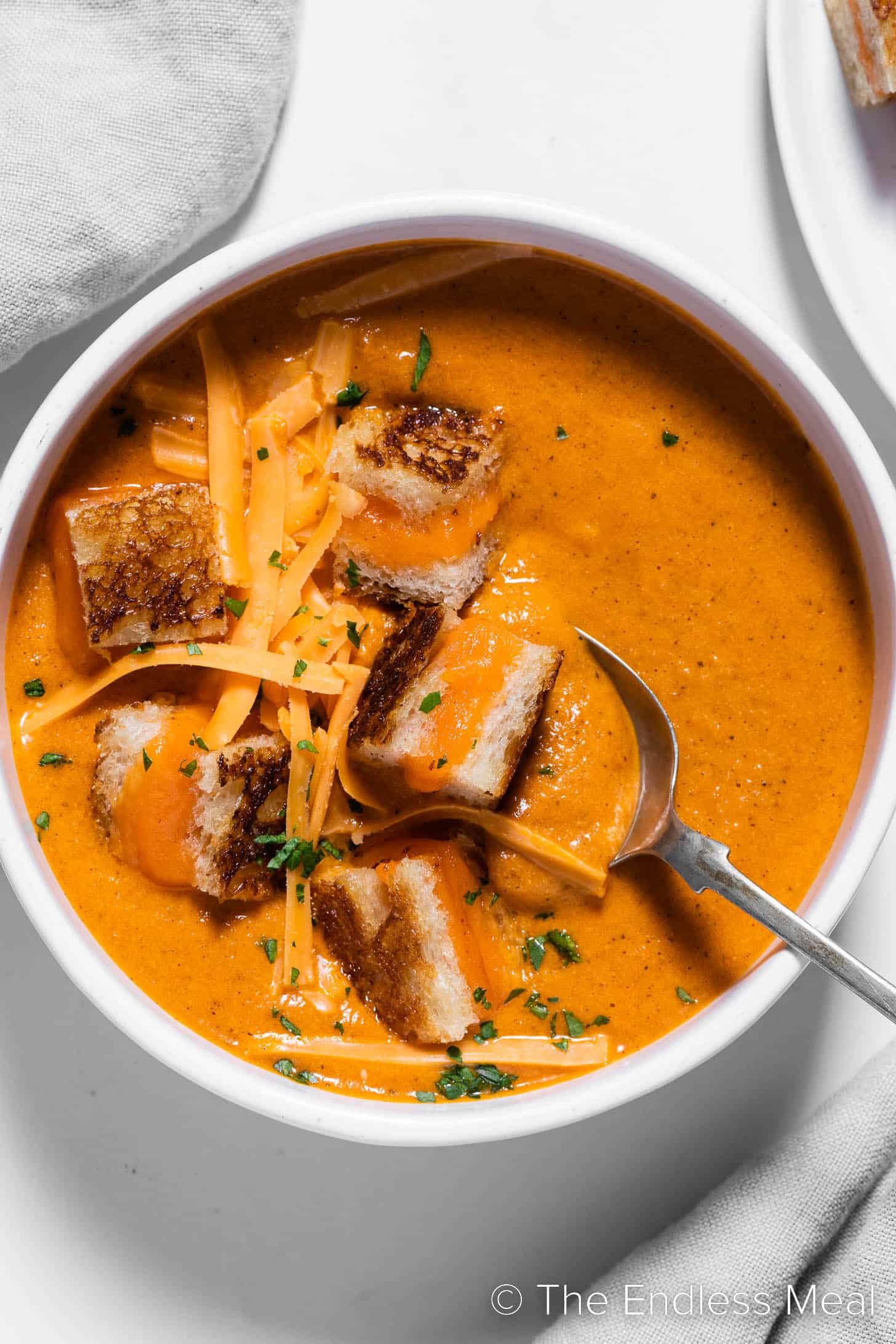 Tomato Cheddar Soup in a bowl with grilled cheese croutons