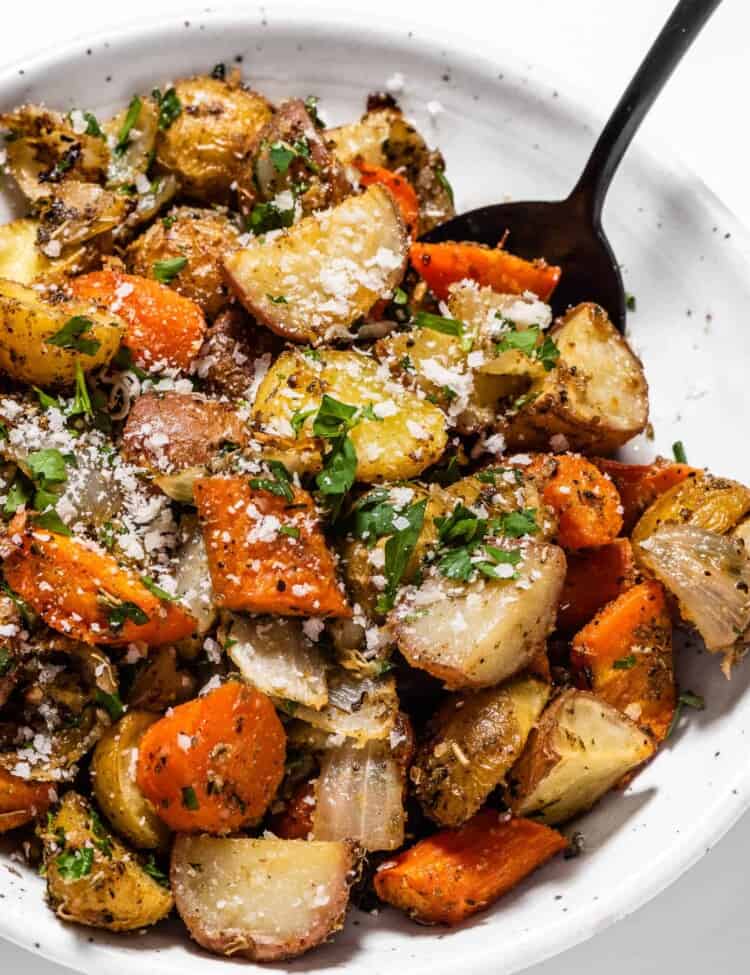 A close up of Roast Carrots Onions and Potatoes in a bowl