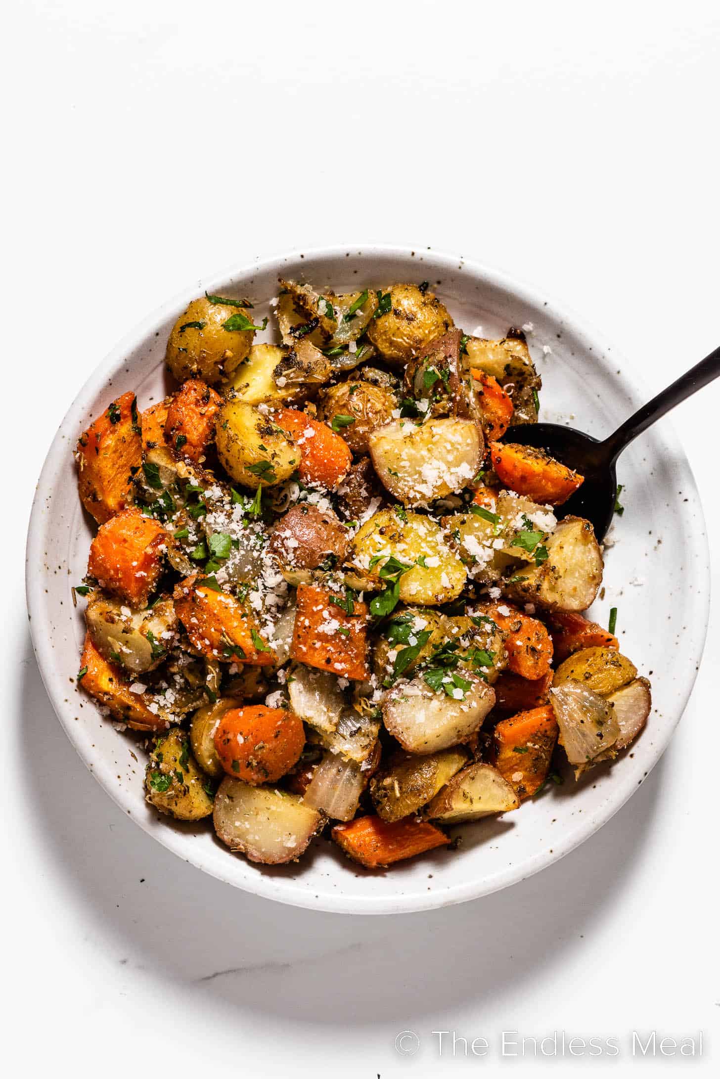 Roast Carrots Onions and Potatoes in a serving bowl
