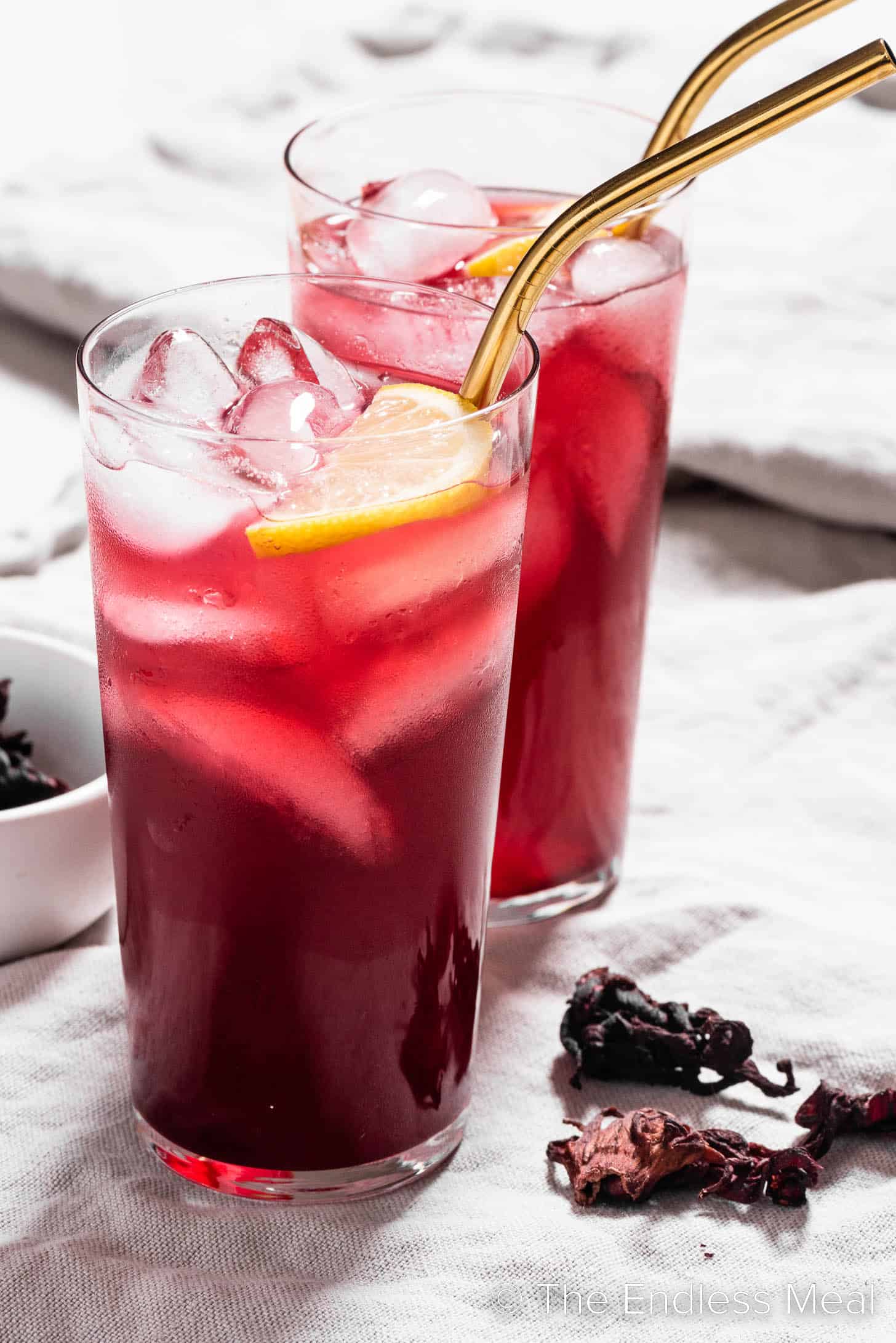 Two tall glasses of lemonade made with dried hibiscus flowers