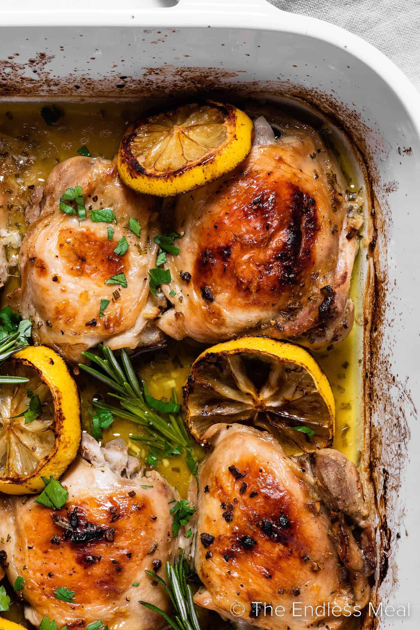 A close up of Lemon Rosemary Chicken in a baking dish
