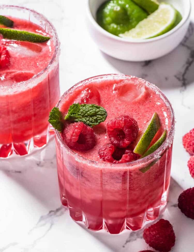 Two Raspberry Margaritas with fresh raspberries.
