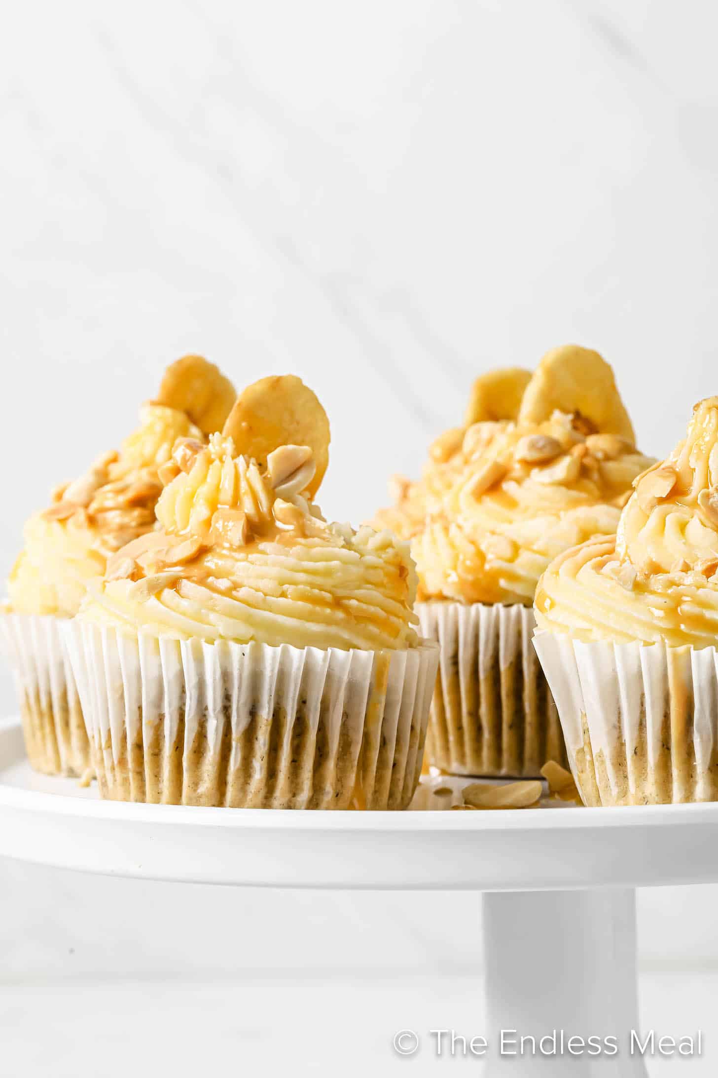 Peanut Butter Banana Cupcakes on a cake stand
