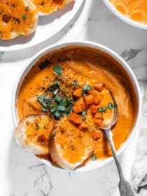 a bowl of Tomato Carrot Soup with cheese toast