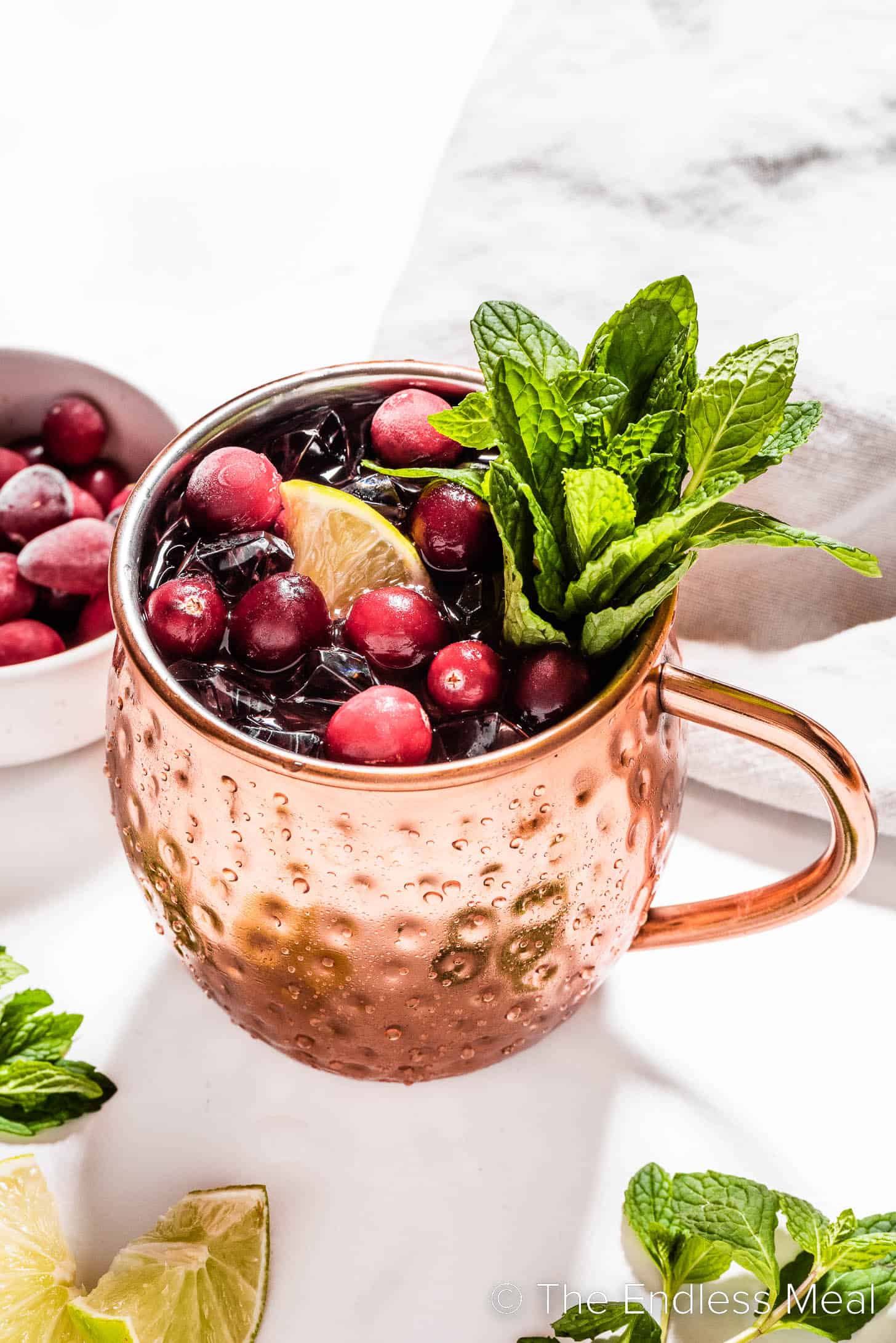A festive cranberry mule in a copper mug