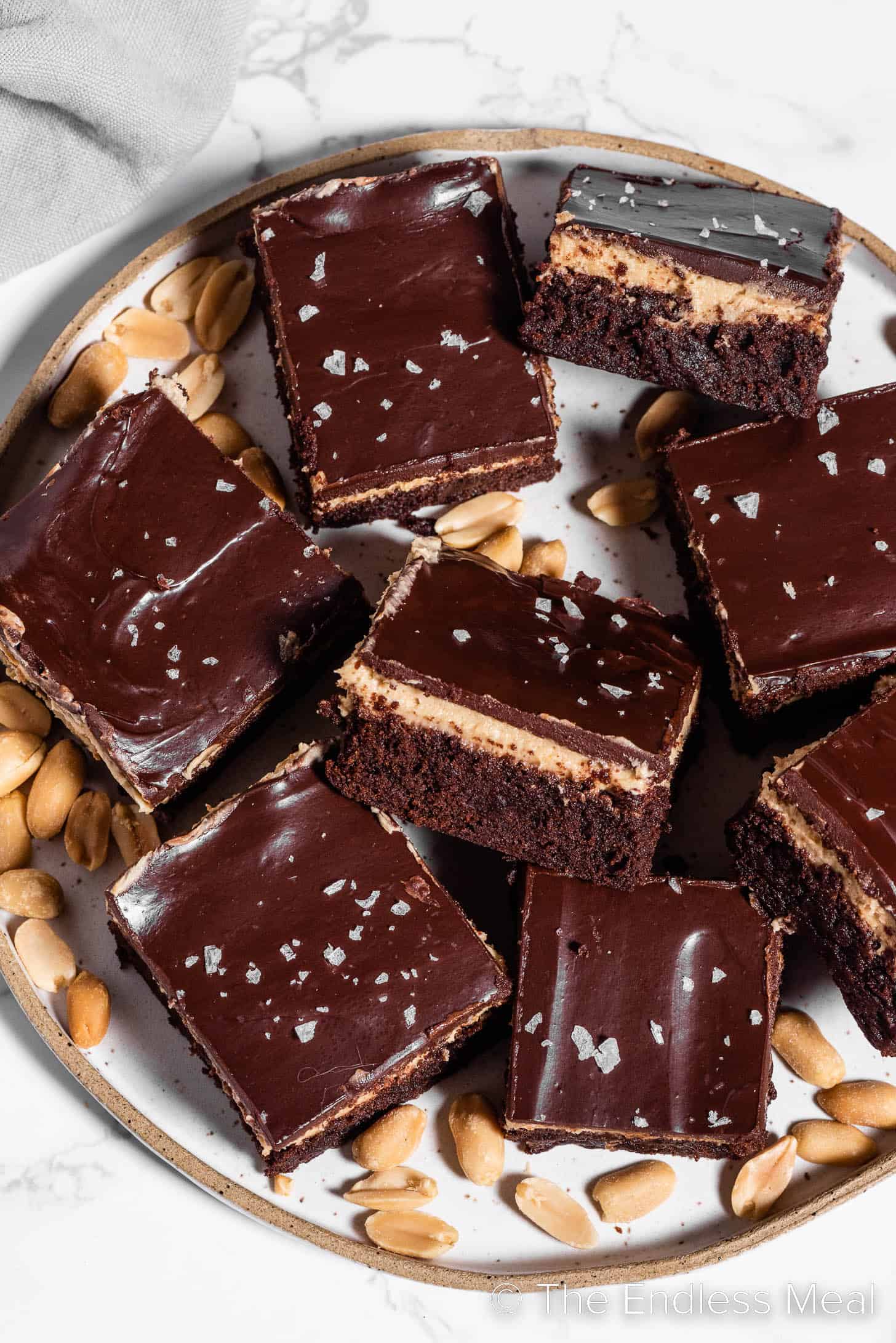A plate of peanut butter brownies with chocolate topping