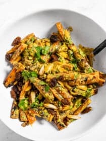Grilled Curried Carrots in a bowl with a serving spoon