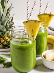 Two Green Breakfast Smoothies with pineapple garnish