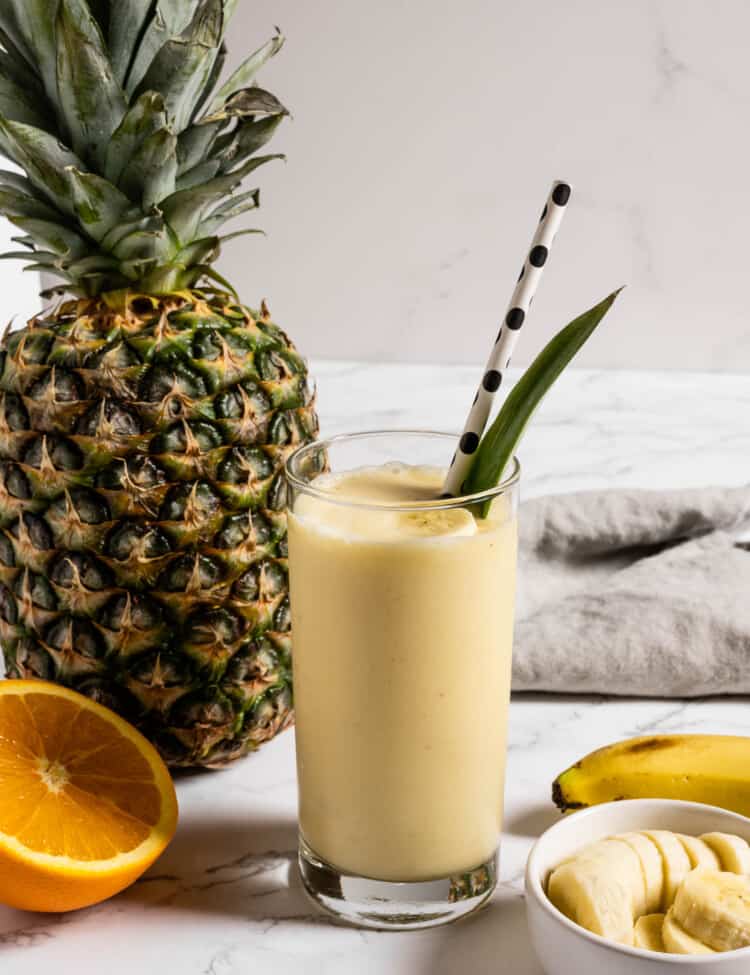 A Pineapple Smoothie next to a pineapple