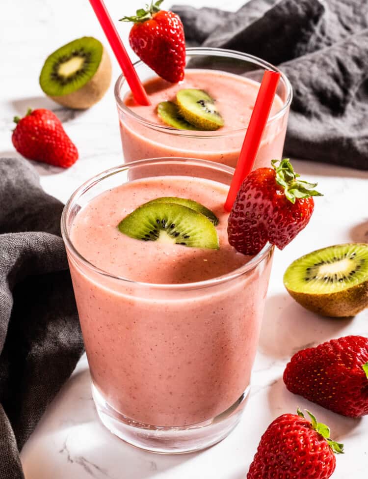 Strawberry Kiwi Smoothie in a glass with a red straw