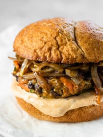 A homemade black bean veggie burger with onions and chipotle mayo