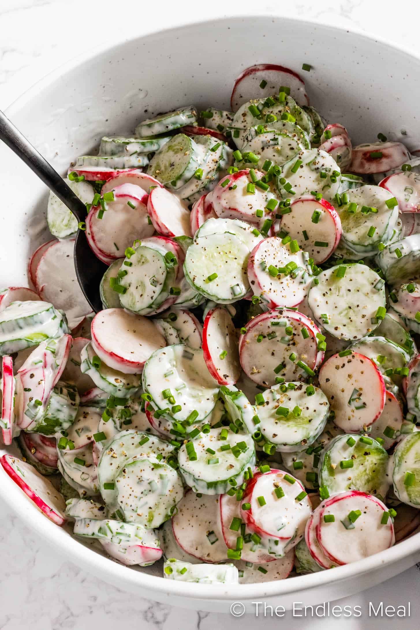 A close up of Cucumber Radish Salad in a serving bowl. 