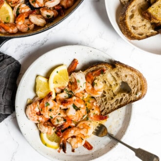 A dinner table with Lemon Garlic Butter Shrimp and bread