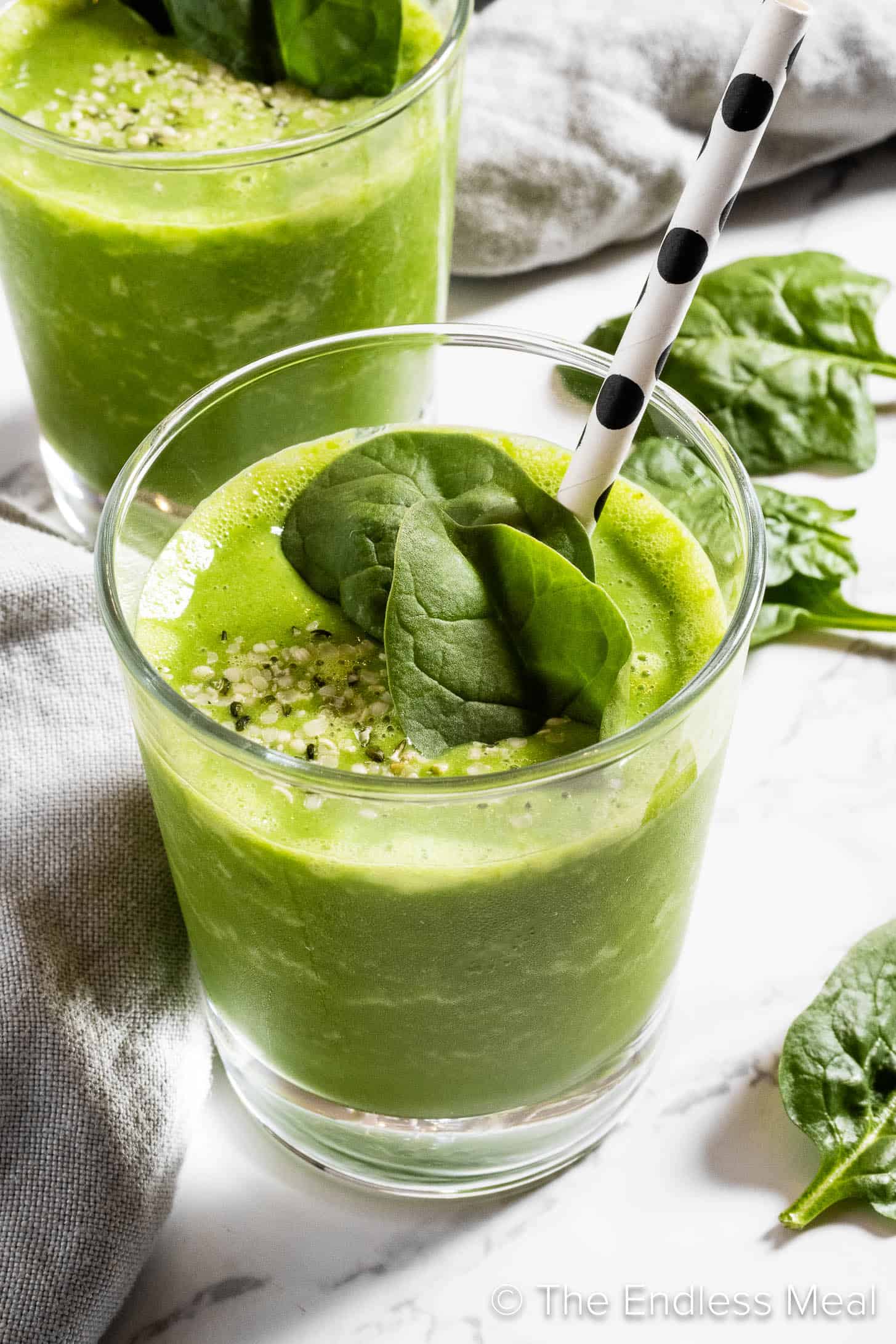 Two spinach smoothies in glasses for breakfast