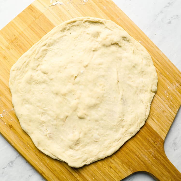 Pizza dough on a pizza peel