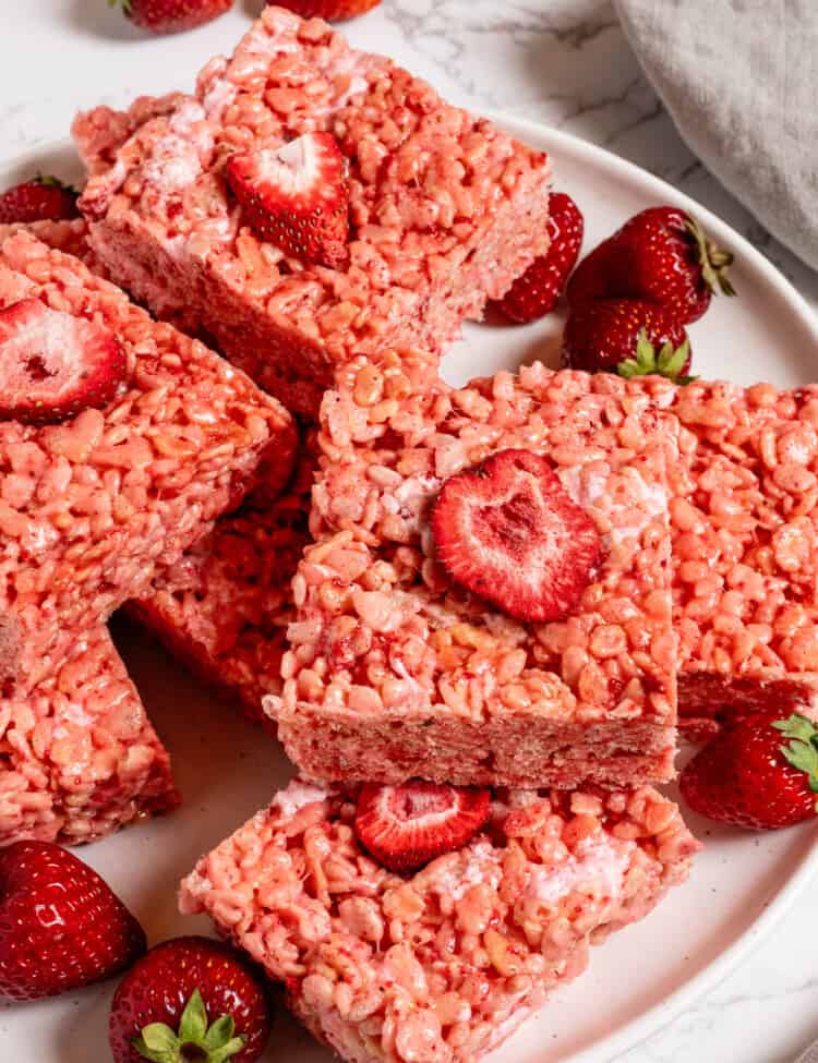 A Strawberry Rice Krispie Treat on a dessert plate with strawberries