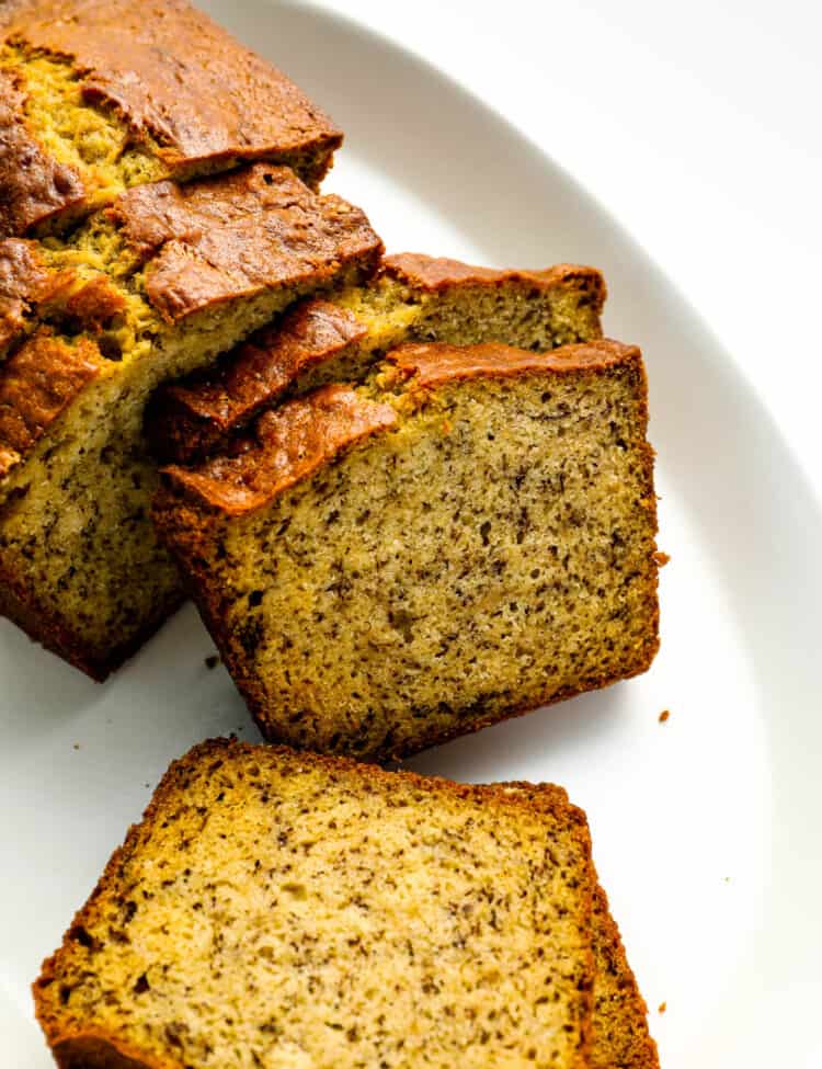 Our Banana Bread Recipe sliced on a serving plate