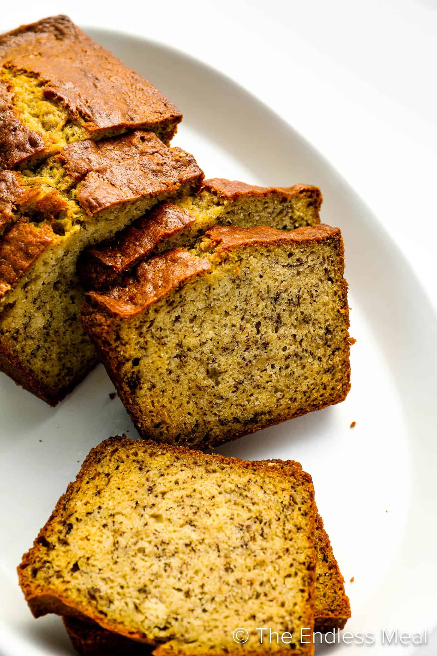 Our Banana Bread Recipe sliced on a serving plate