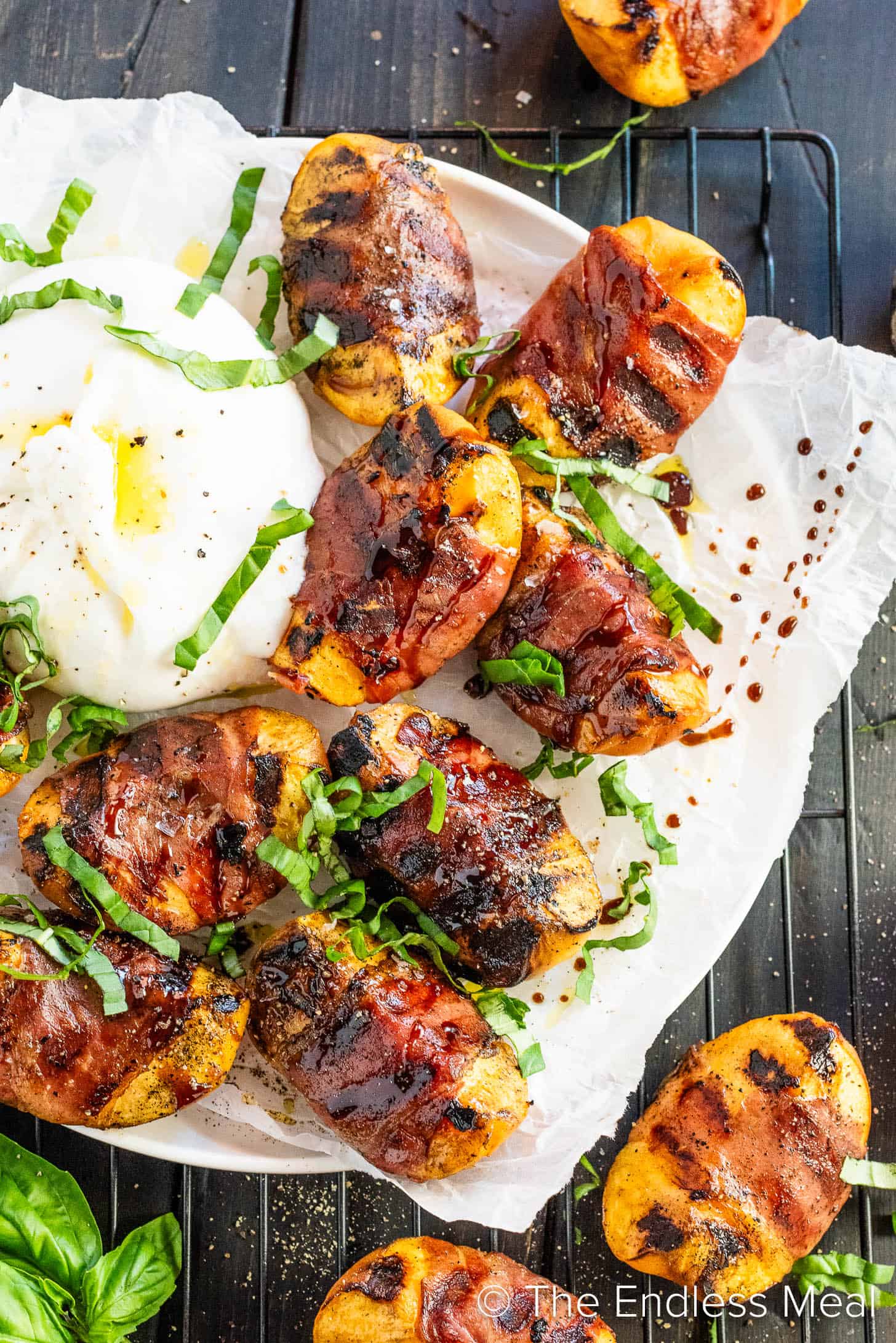 Prosciutto Wrapped Grilled Peaches on a serving plate