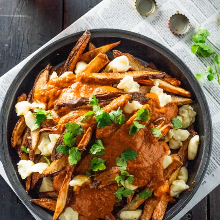 a big bowl of Butter Chicken Poutine