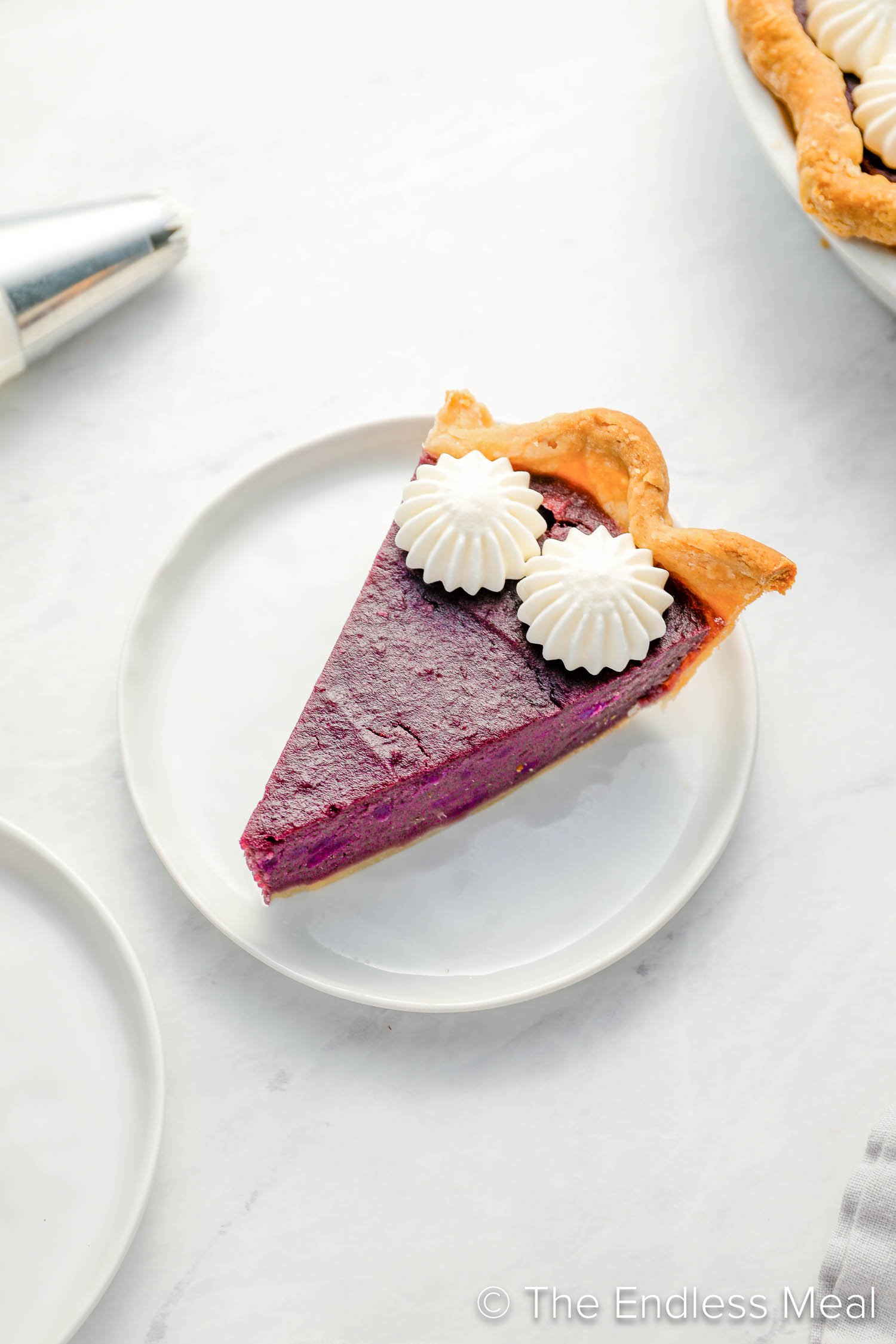 A slice of Purple Sweet Potato Pie on a dessert plate.