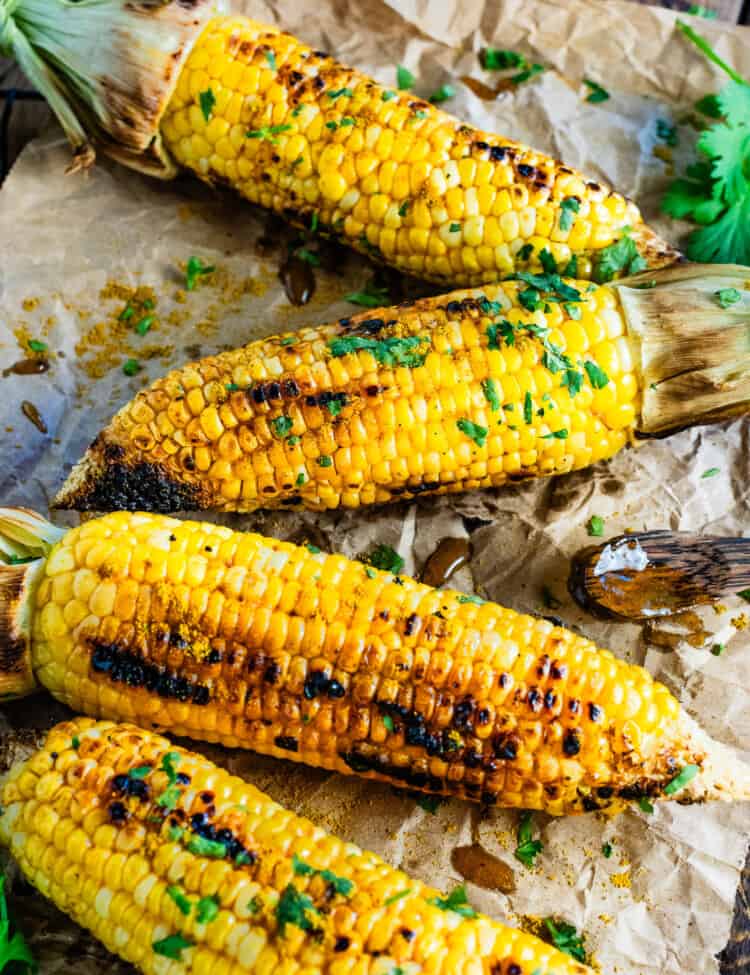 A close up of 4 cobs of Curry Corn on the Cob