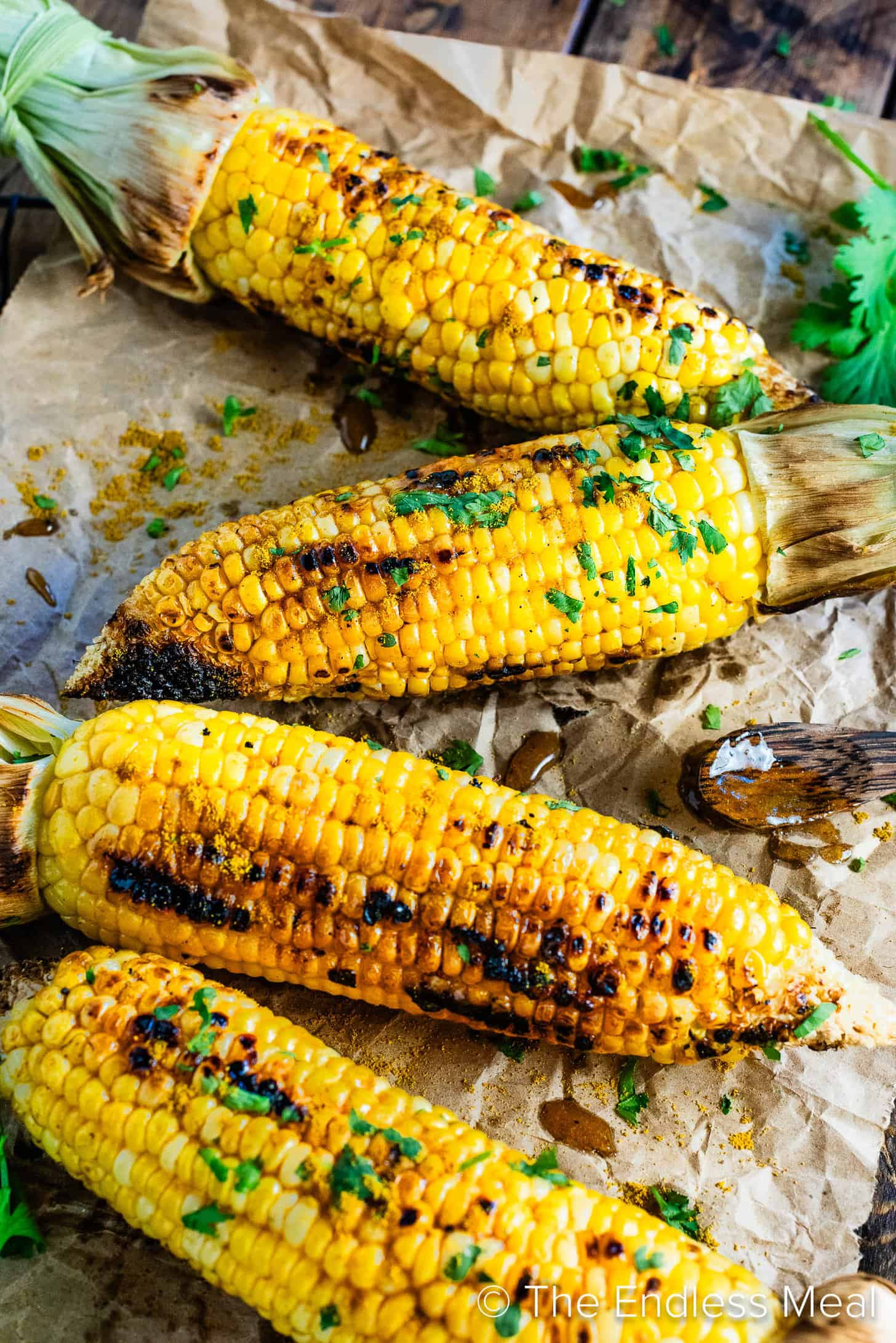 A close up of 4 cobs of Curry Corn on the Cob