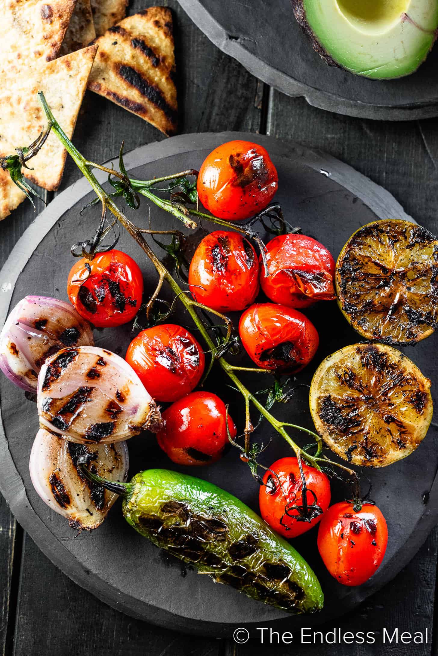 A plate of grilled vegetables to be made into guacamole