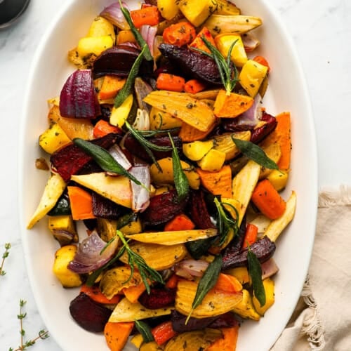 Roasted Root Vegetables on a white serving plate on the dinner table