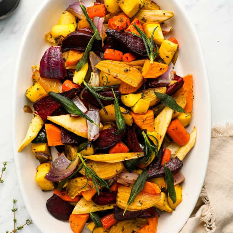 Roasted Root Vegetables on a white serving plate on the dinner table
