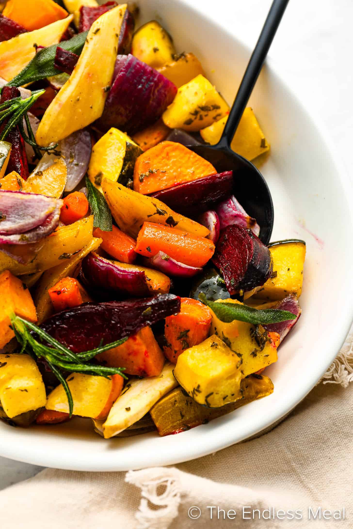 a close up of Roasted Root Vegetables in a dinner serving dish
