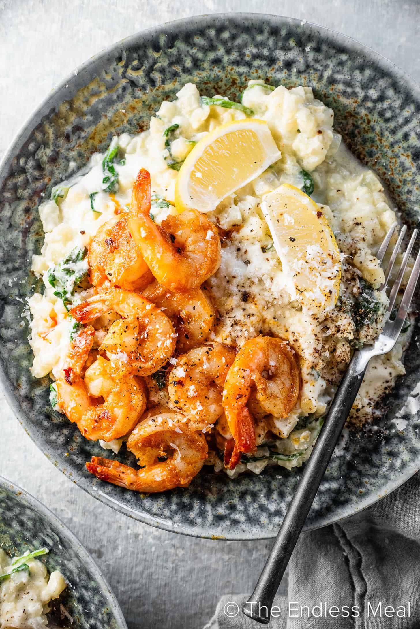 a dinner bowl with Cauliflower Rice Risotto topped with shrimp