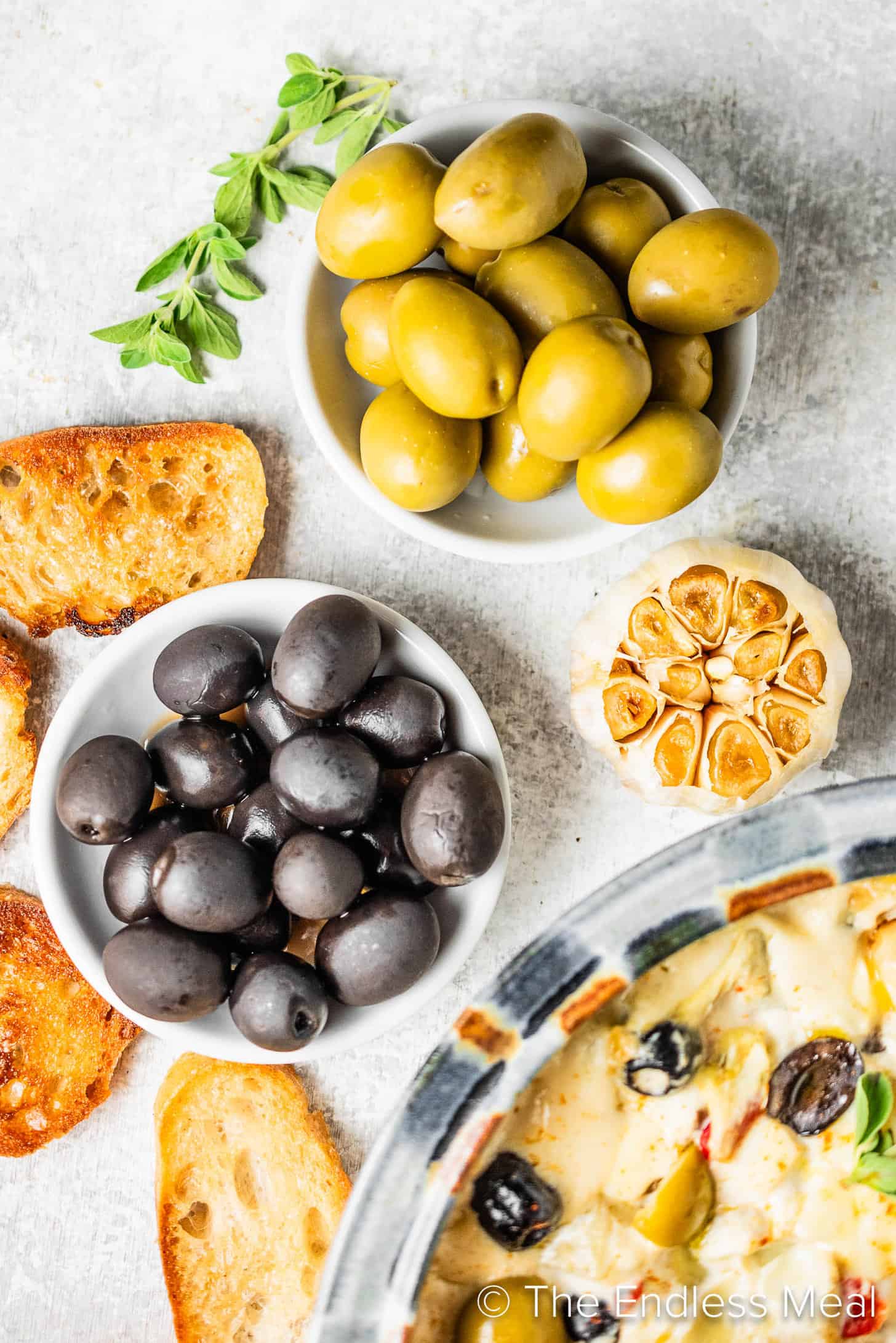 Olives next to a Cheesy Baked Olive Dip