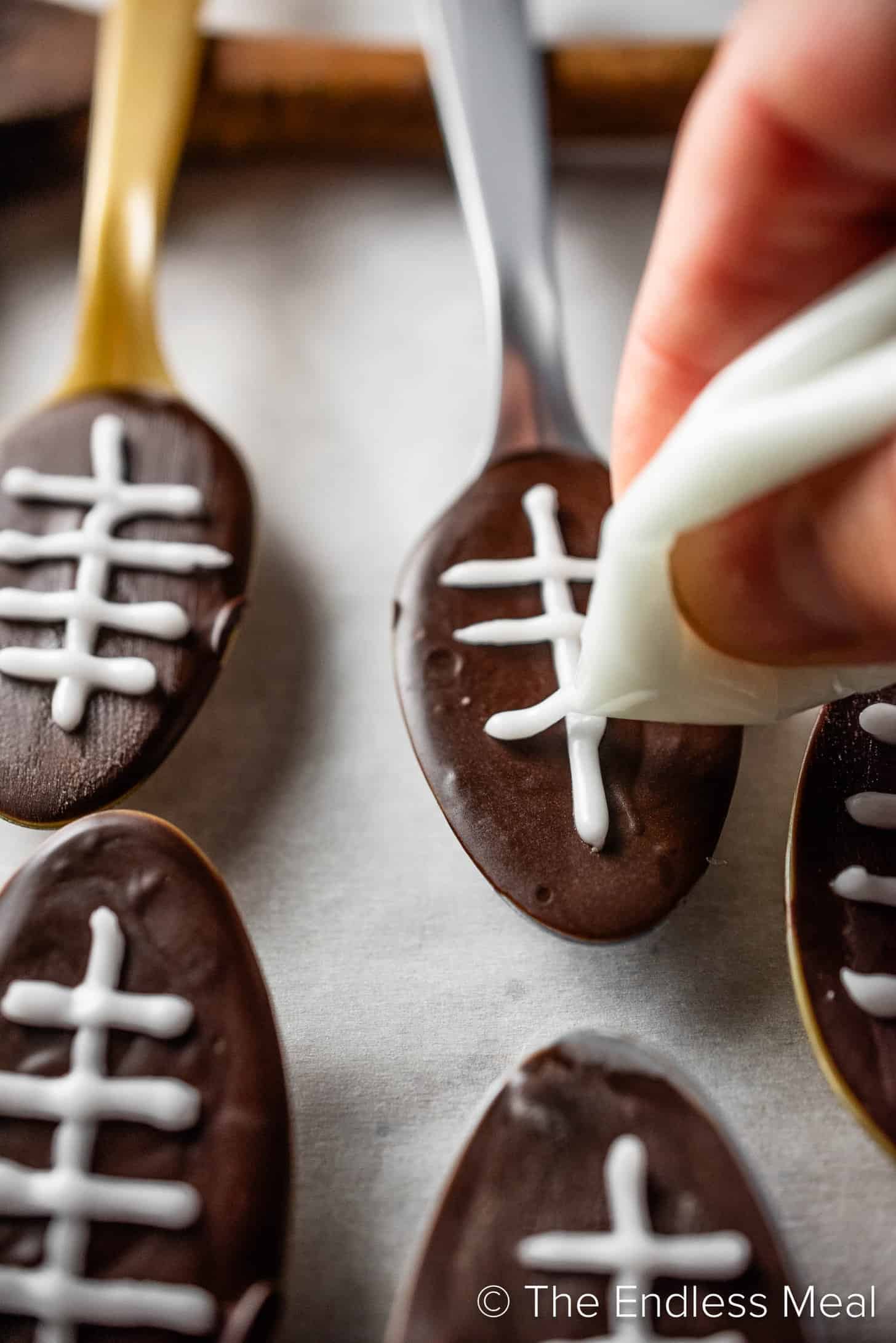 Making chocolate football spoons for Super Bowl Sunday Dessert