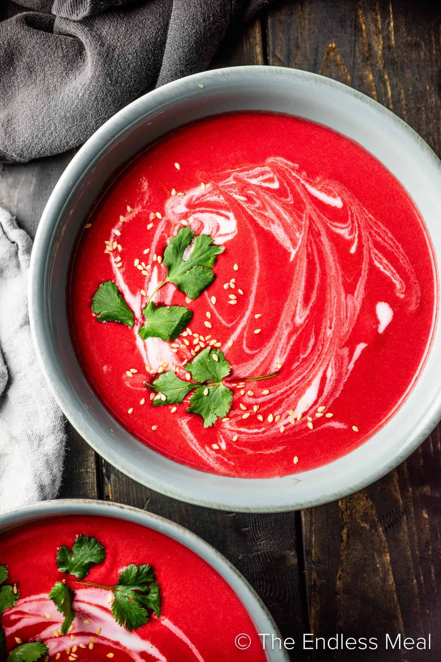 Two bowls of Thai Beet Soup on the dinner table