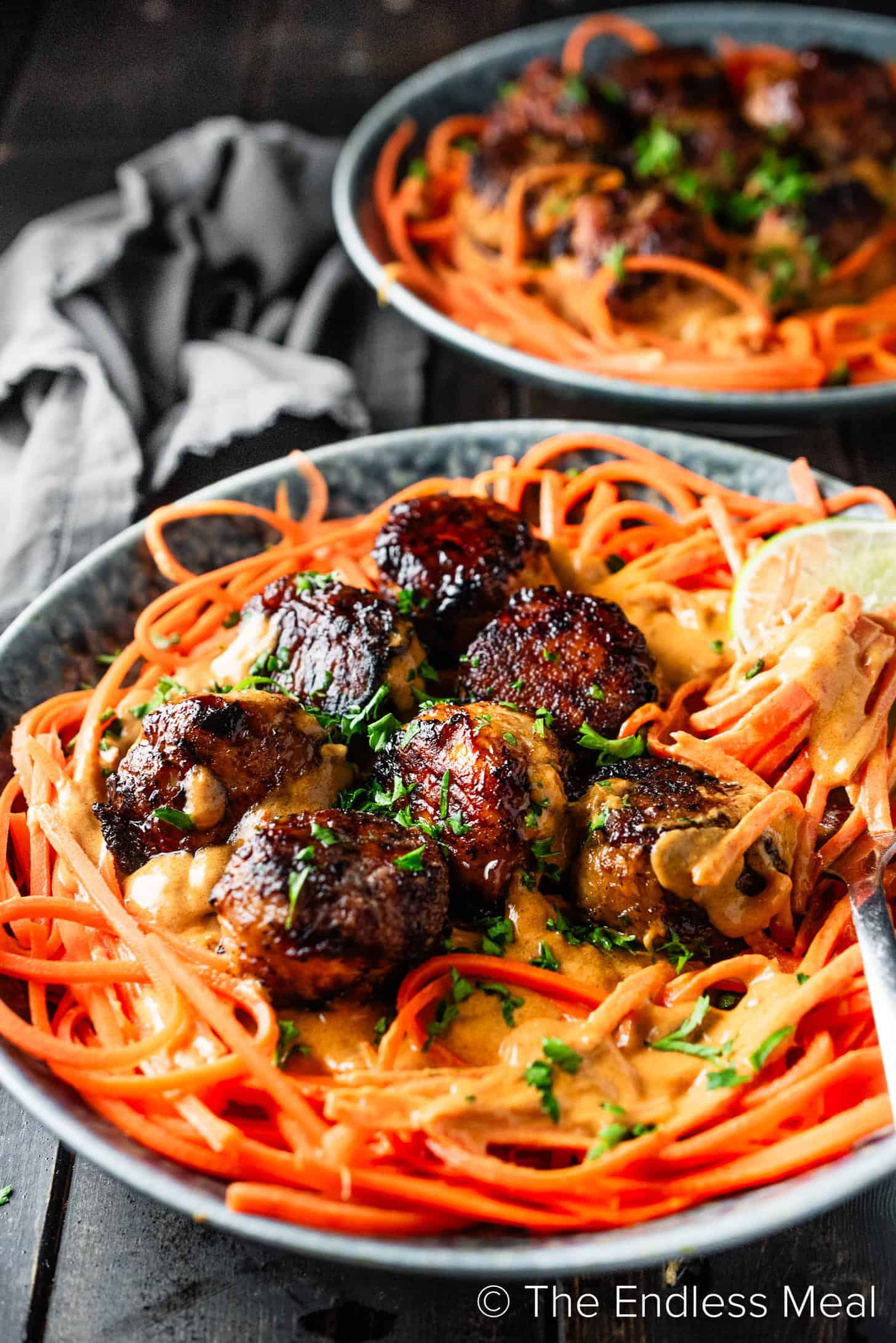 A close up of Thai Curry Meatballs with noodles and peanut sauce