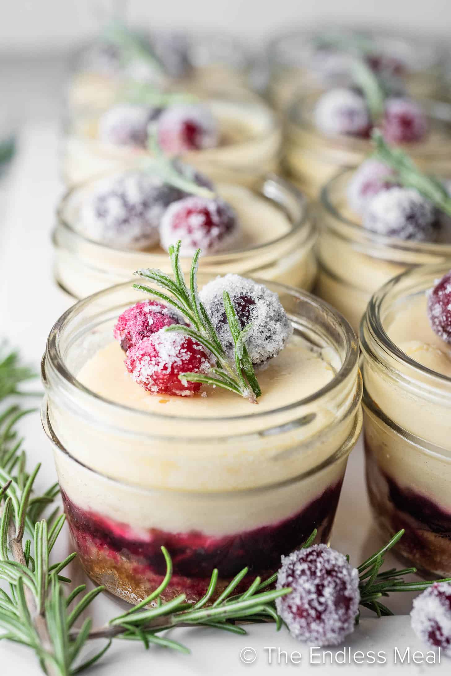 White Chocolate Cranberry Cheesecakes on a dessert tray
