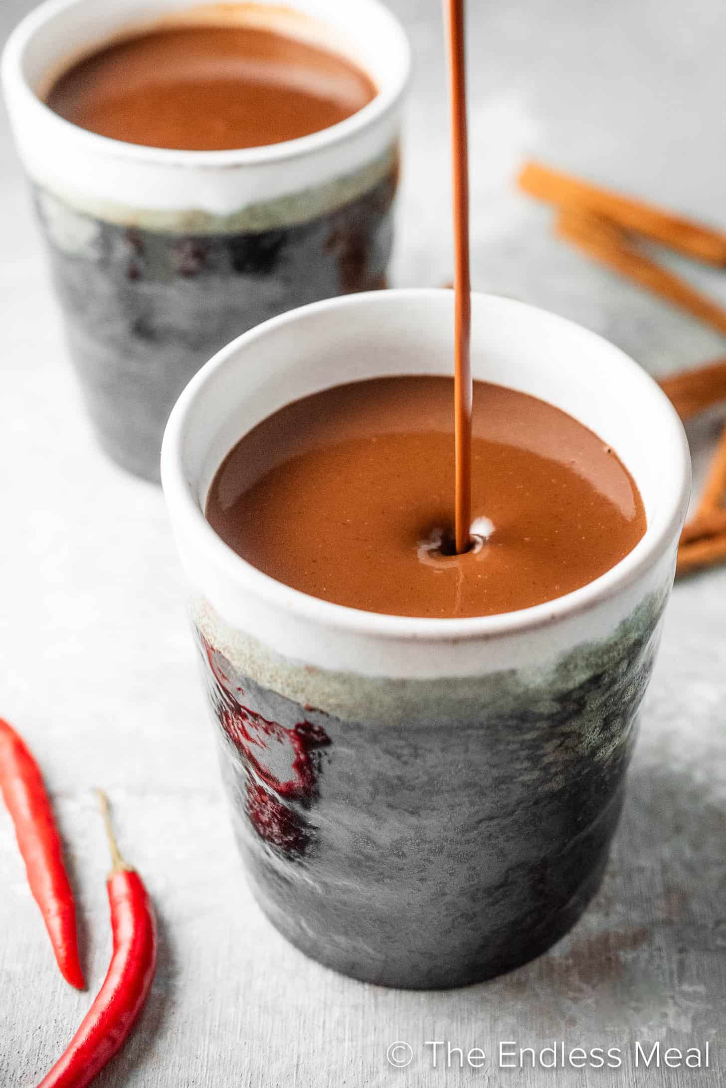 Spicy Hot Chocolate being poured into a mug