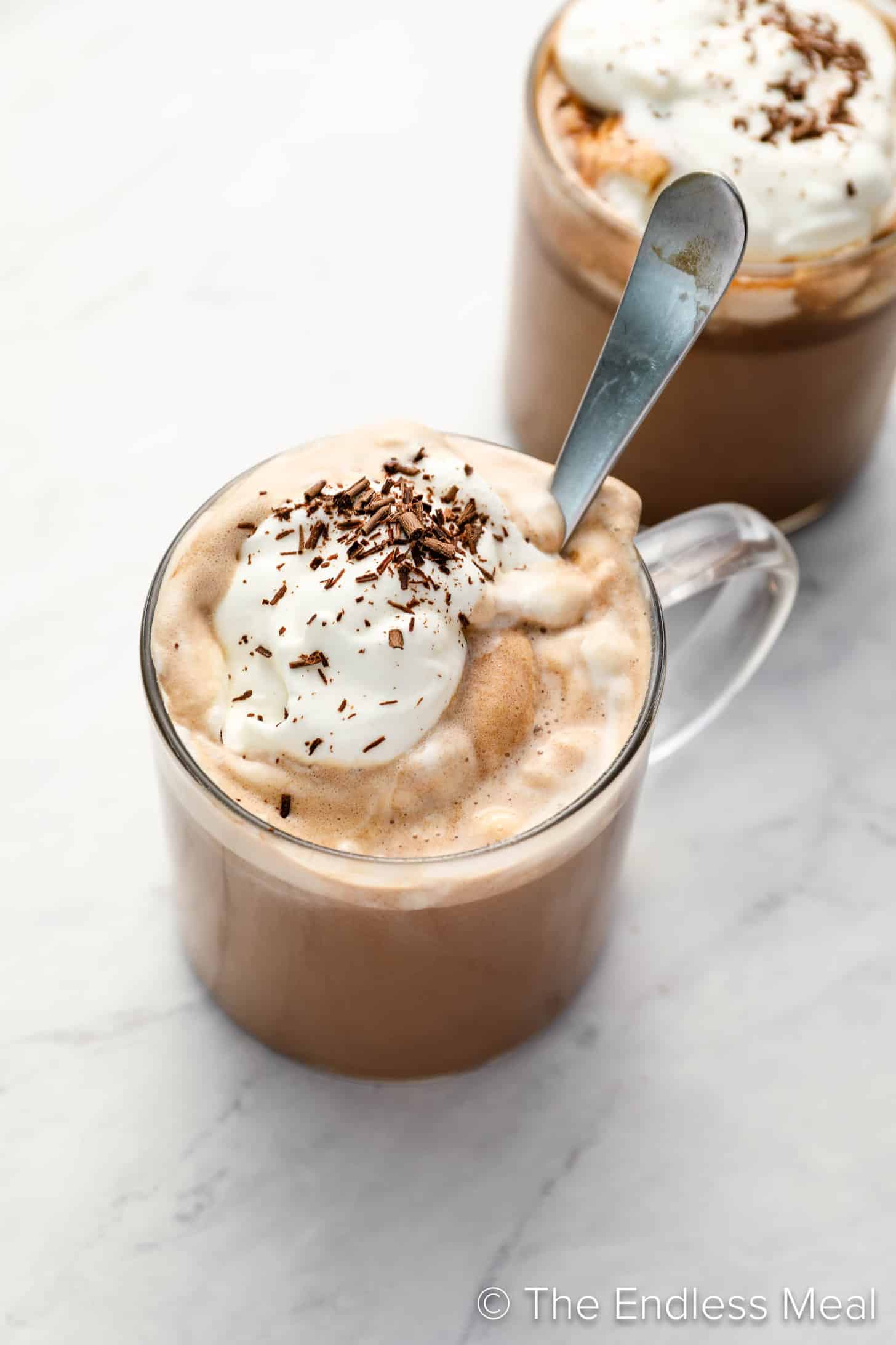 Two mugs of Spiked Hot Chocolate with whipped cream