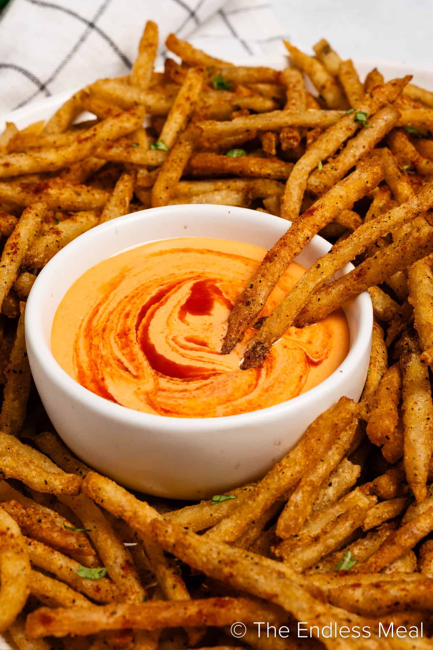 A close up of Sriracha Mayonnaise and fries