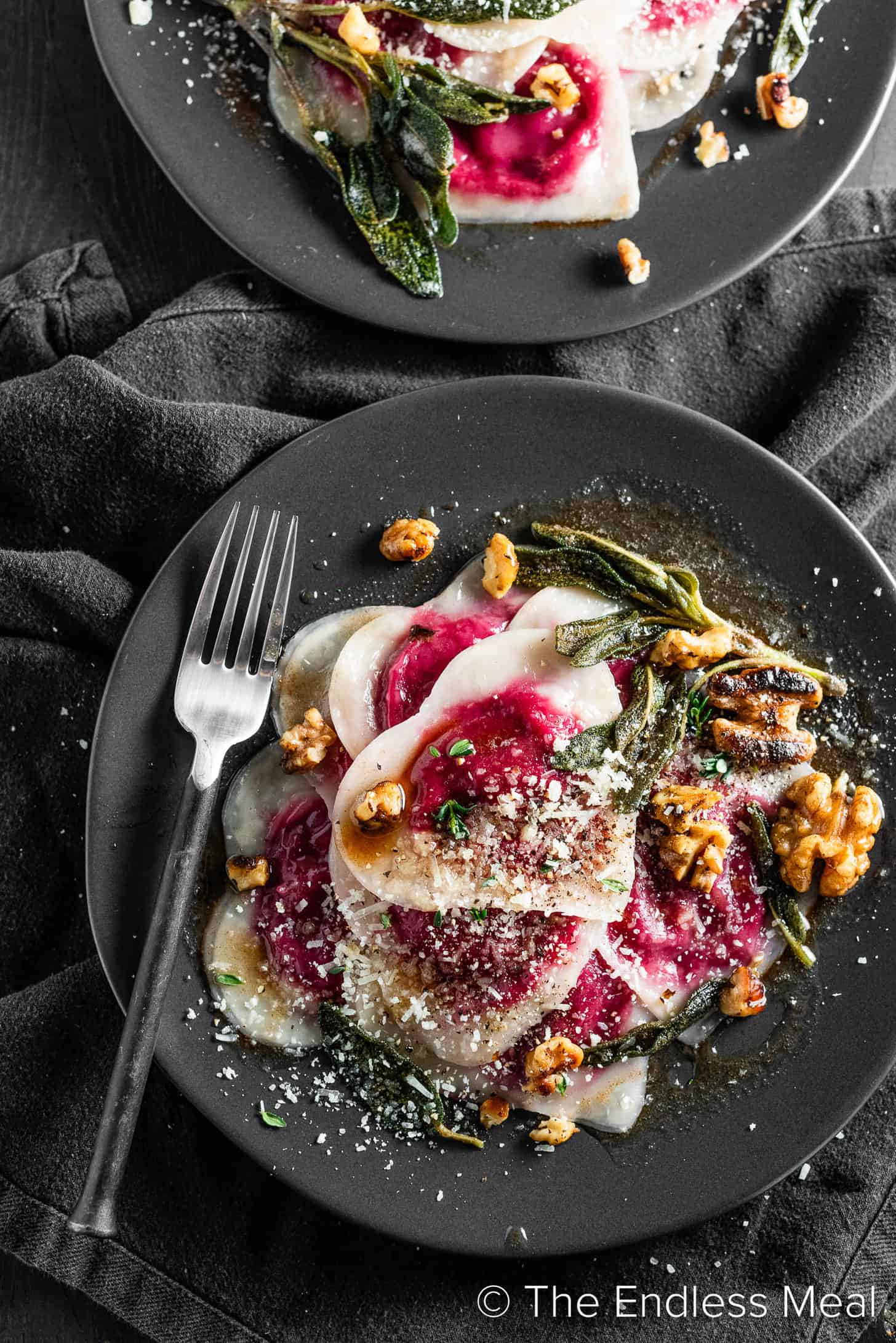 Beet and Goat Cheese Ravioli on a black dinner plate