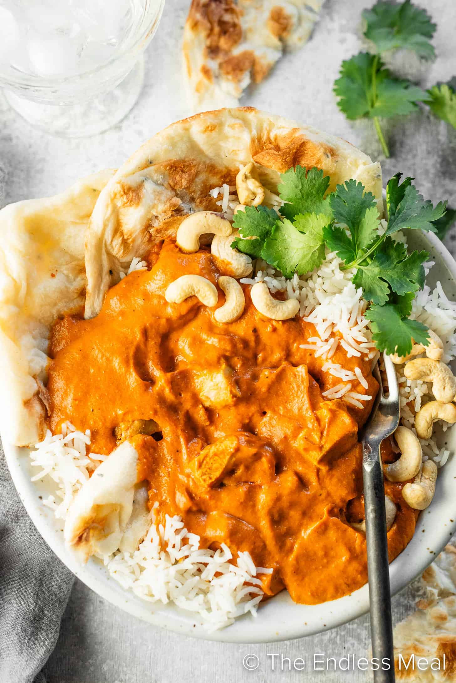 A close up of Cashew Butter Chicken in a bowl with rice