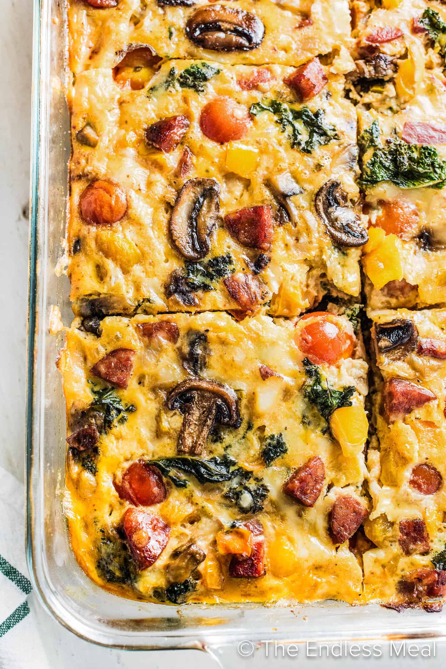 A close up of a slice of Chorizo Breakfast Casserole in a baking dish