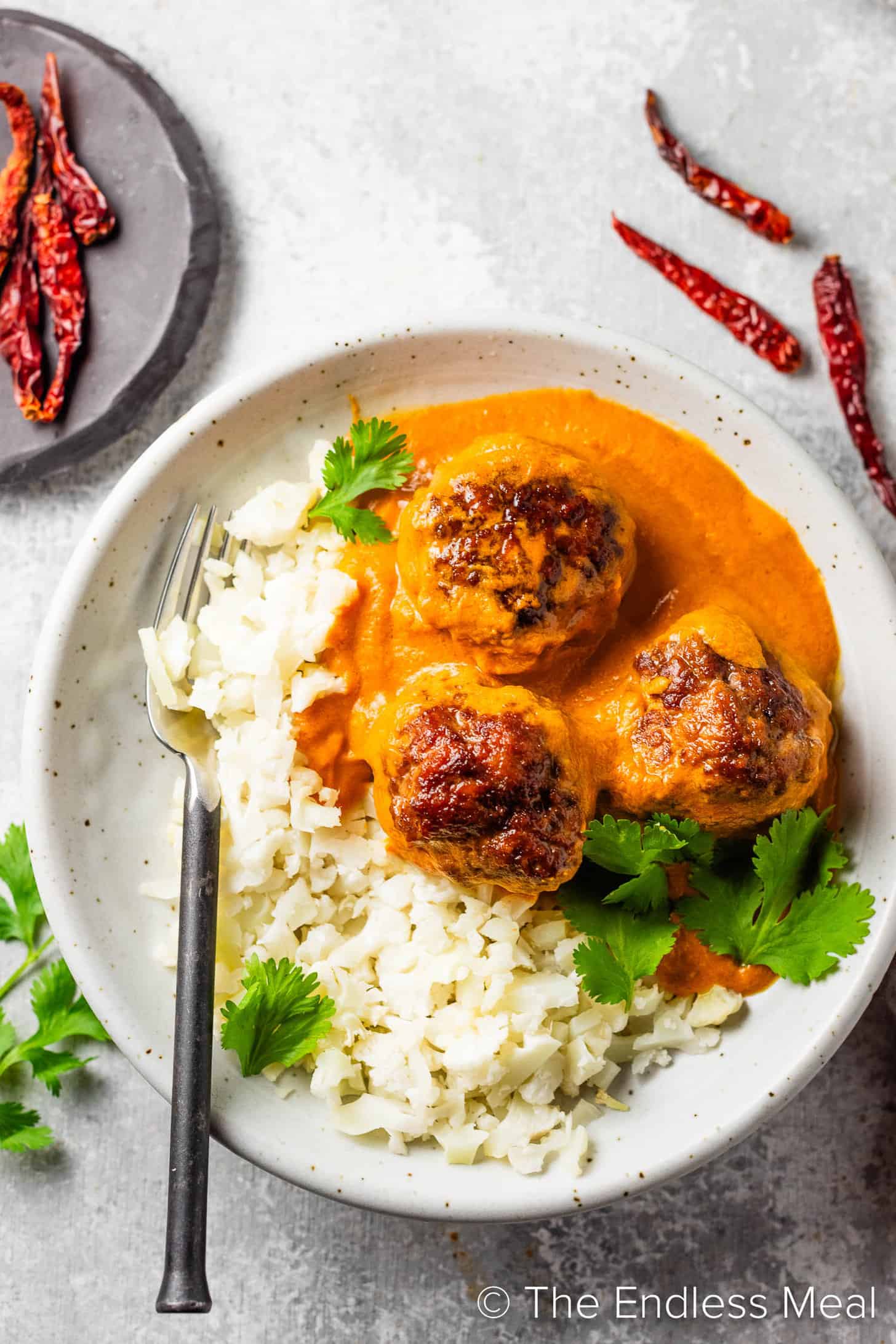 A dinner plate with Indian Meatball Curry and rice