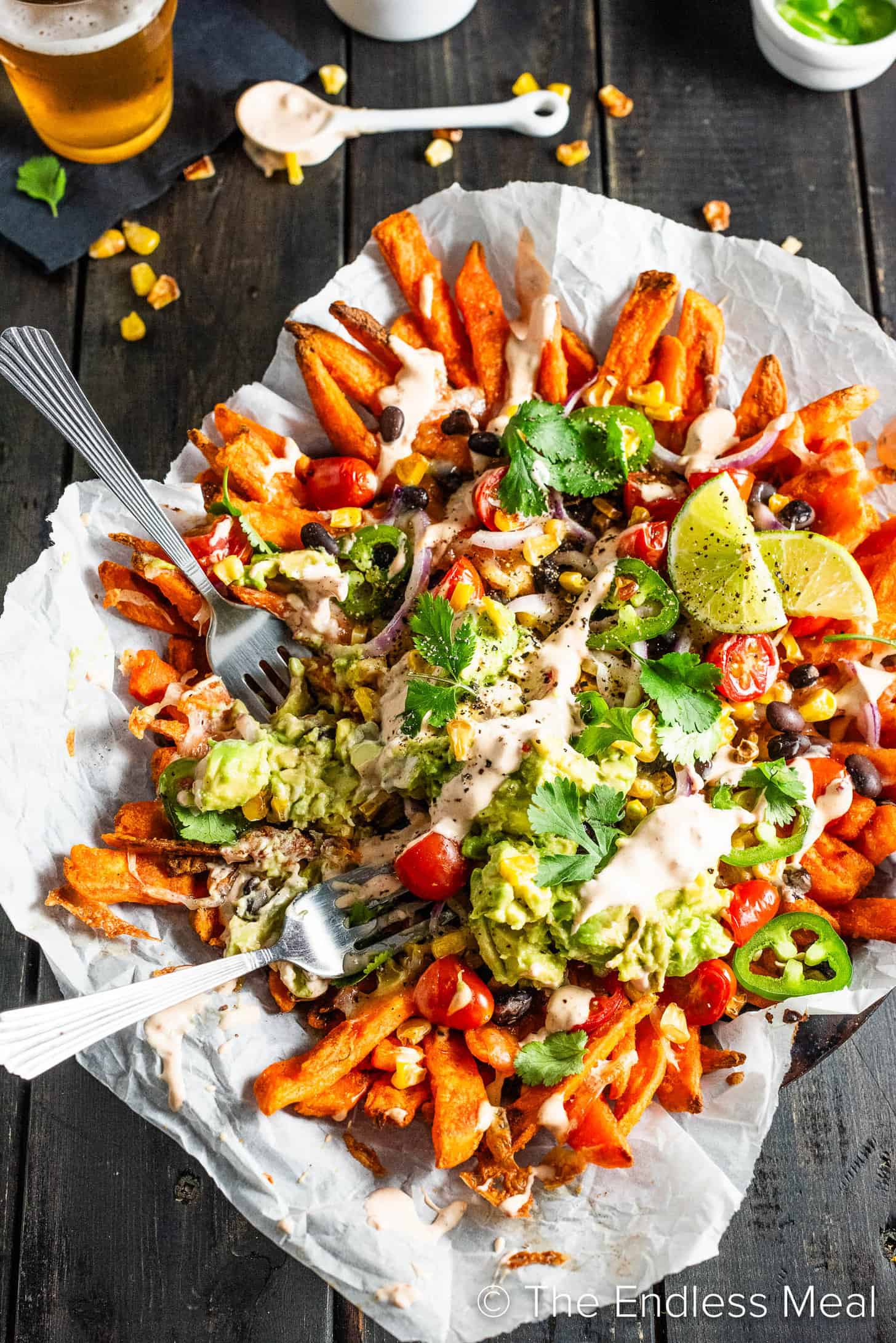 2 forks in a pile of loaded Mexican Fries