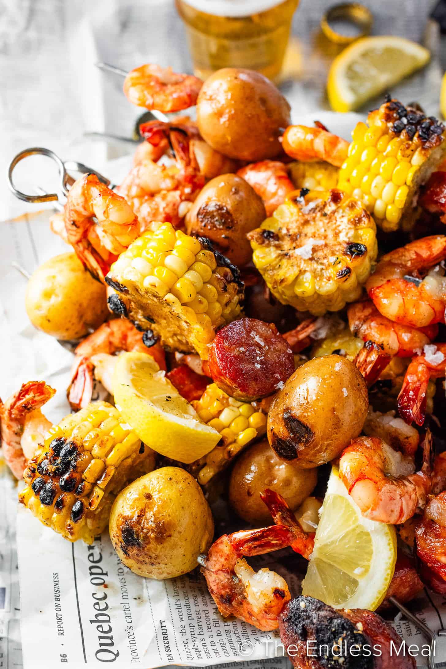 Shrimp Boil Skewers with Cajun seasoning on a serving tray