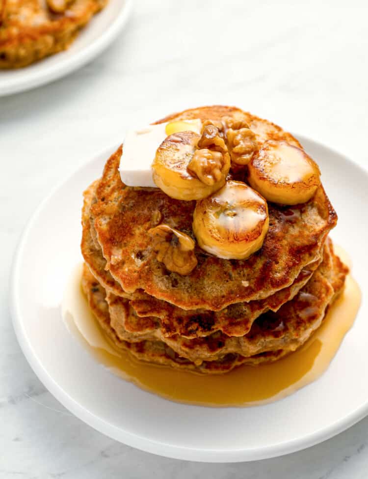 A stack of Banana Protein Pancakes with maple syrup